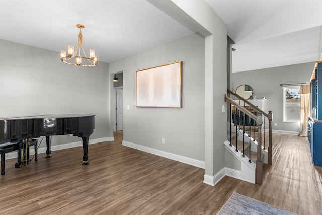 entrance foyer featuring dark wood-type flooring and an inviting chandelier