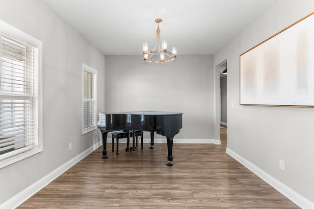 miscellaneous room featuring hardwood / wood-style floors and a notable chandelier