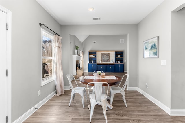 dining space with light hardwood / wood-style floors