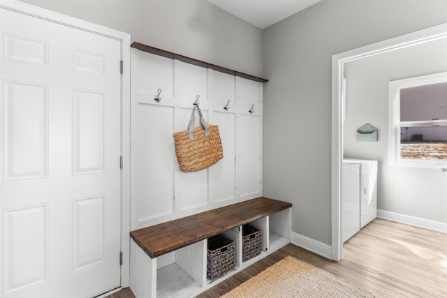 mudroom with separate washer and dryer and light wood-type flooring