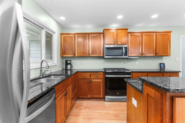 1060 Old Rock Rd, Greensboro, GA 30642 - kitchen with stainless steel appliances, brown cabinets, light wood-type flooring, and recessed lighting