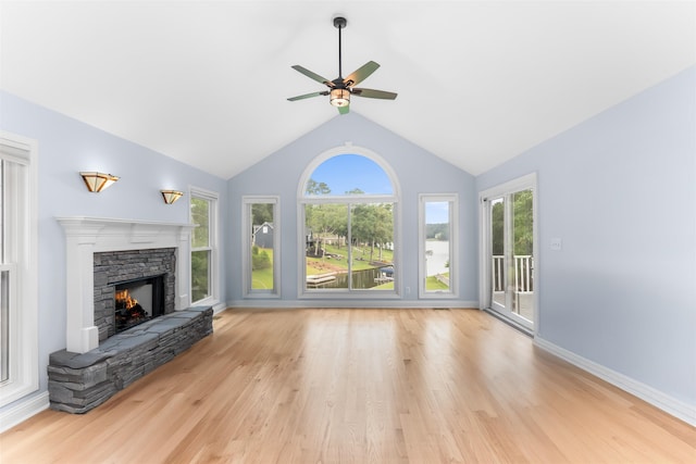 1060 Old Rock Rd, Greensboro, GA 30642 - unfurnished living room featuring a fireplace, healthy amount of natural light, ceiling fan, lofted ceiling, and wood finished floors