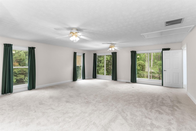1060 Old Rock Rd, Greensboro, GA 30642 - empty room with attic access, a ceiling fan, baseboards, carpet floors, and a textured ceiling