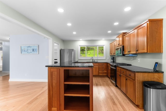 1060 Old Rock Rd, Greensboro, GA 30642 - kitchen with stainless steel appliances, open shelves, light wood finished floors, a center island, and a sink