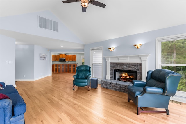 1060 Old Rock Rd, Greensboro, GA 30642 - living area with ceiling fan, light wood-type flooring, plenty of natural light, a fireplace, and high vaulted ceiling
