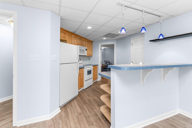 1060 Old Rock Rd, Greensboro, GA 30642 - kitchen featuring white appliances, open shelves, light wood-style floors, a drop ceiling, and a breakfast bar area