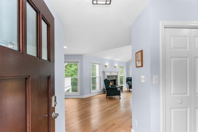 1060 Old Rock Rd, Greensboro, GA 30642 - foyer entrance featuring a stone fireplace, light wood-style floors, and baseboards