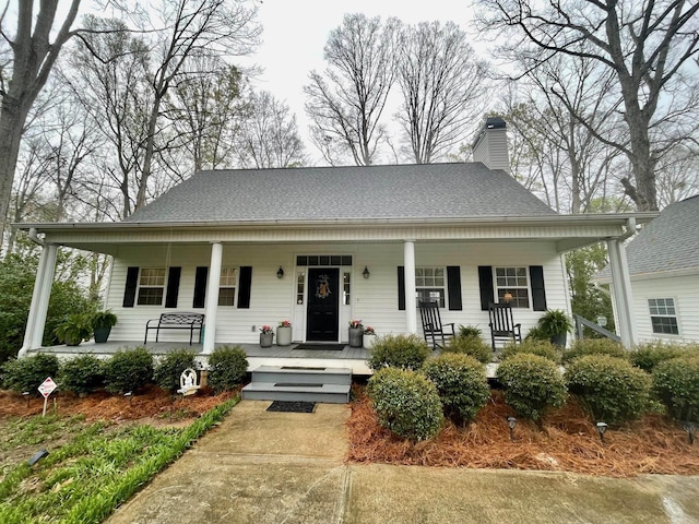 bungalow-style home with a chimney and covered porch