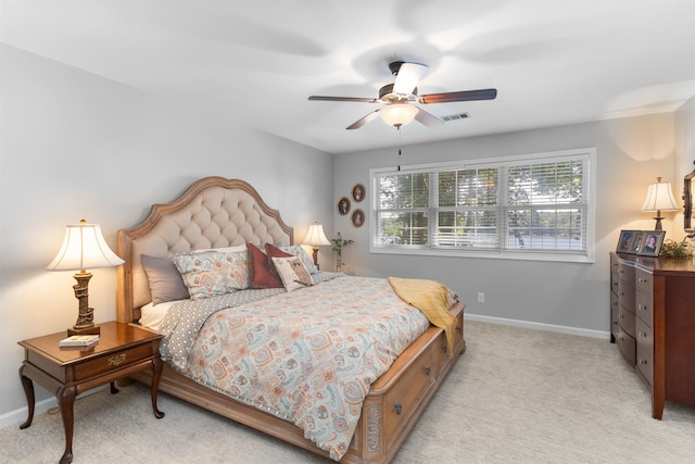 bedroom with light colored carpet, baseboards, and ceiling fan