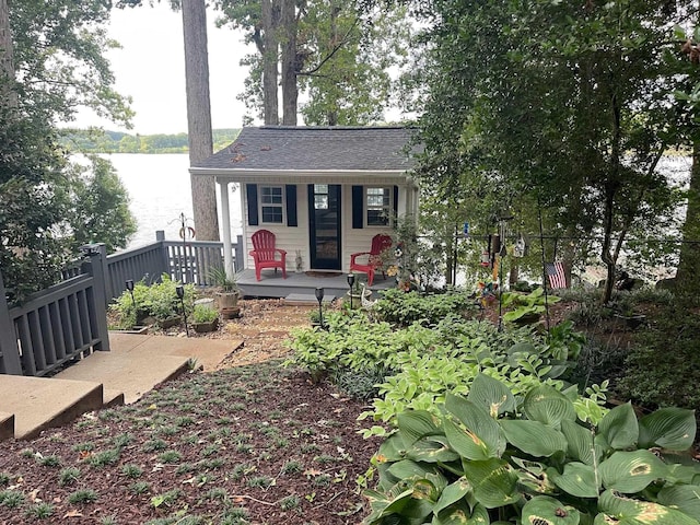 view of front of home featuring a water view and fence