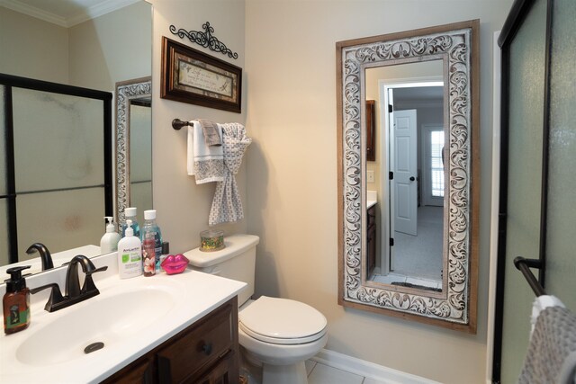 bathroom with crown molding, toilet, vanity, and baseboards