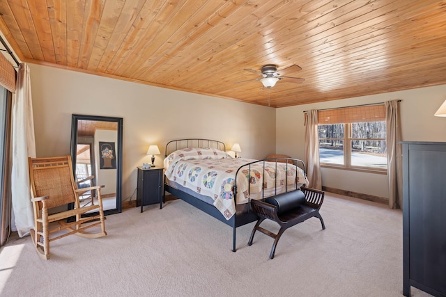 bedroom featuring baseboards, wooden ceiling, and light colored carpet