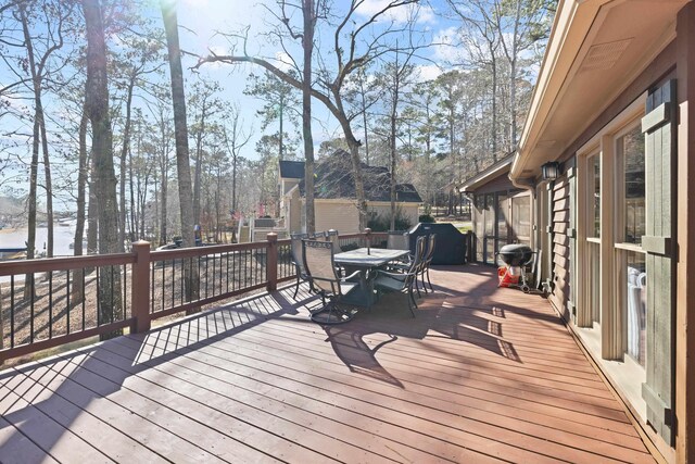 wooden deck with outdoor dining space