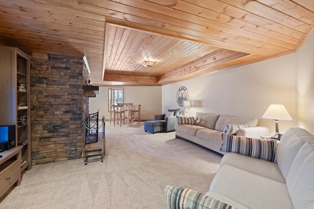 living room with wood ceiling, a tray ceiling, and carpet flooring
