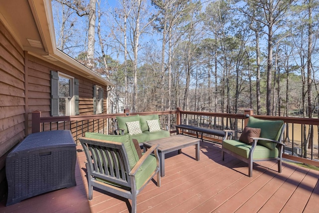 deck with an outdoor hangout area and a forest view