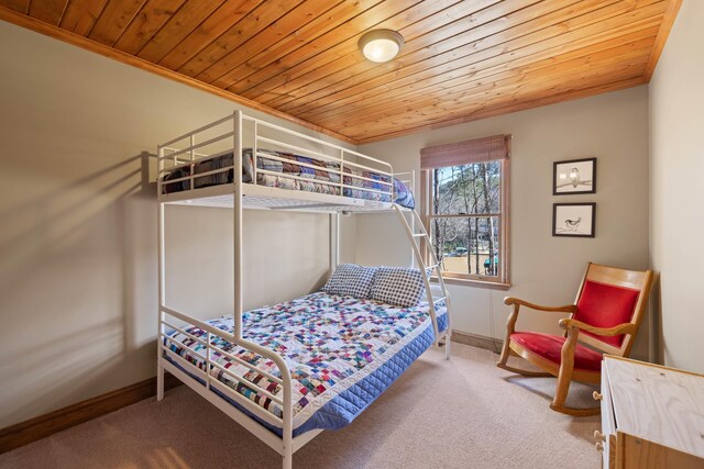bedroom with carpet, wood ceiling, crown molding, and baseboards