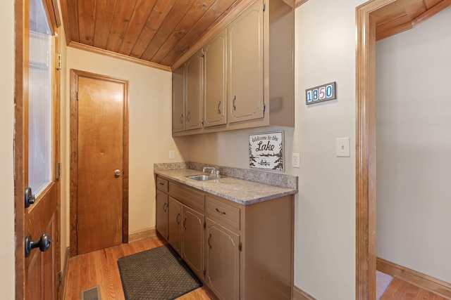 interior space with light countertops, visible vents, light wood-style flooring, wood ceiling, and a sink