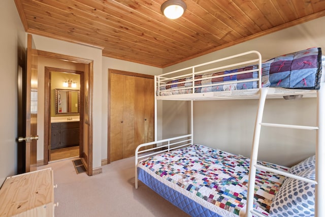 bedroom with wood ceiling, a closet, and carpet flooring