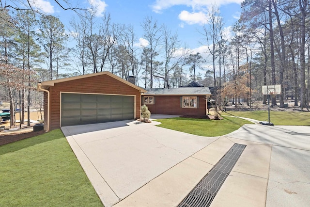 view of front of property with driveway, a garage, a chimney, and a front yard