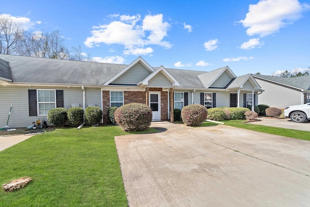 view of front facade with brick siding and a front lawn