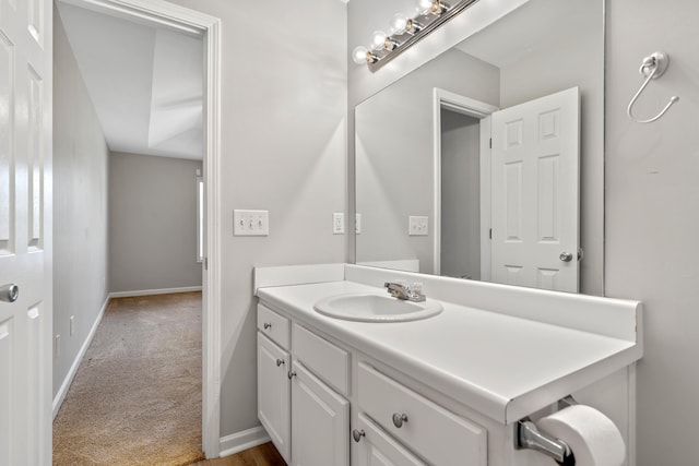 bathroom featuring baseboards and vanity