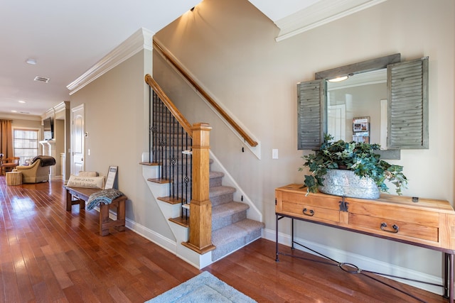 stairs featuring hardwood / wood-style floors and crown molding