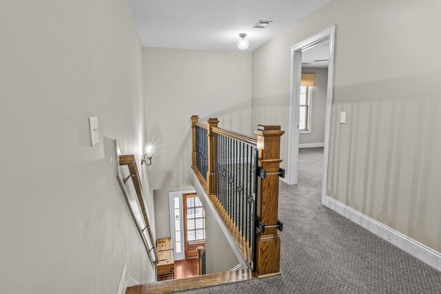 living room with crown molding, a high end fireplace, built in shelves, and hardwood / wood-style floors