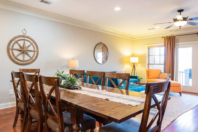 kitchen with stainless steel appliances, decorative light fixtures, a breakfast bar, and light hardwood / wood-style flooring