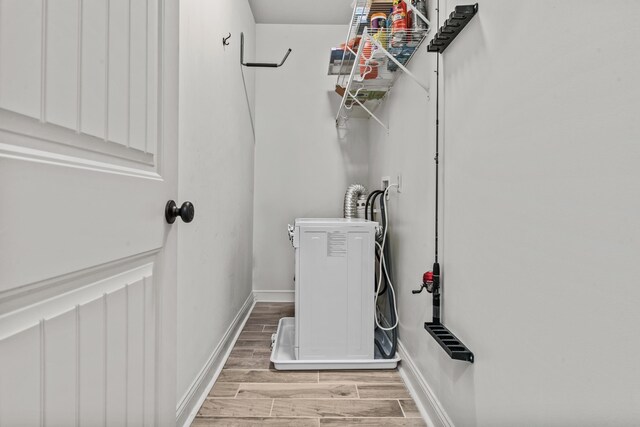 corridor featuring crown molding and light wood-type flooring