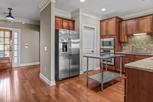 bathroom with crown molding, toilet, and hardwood / wood-style floors