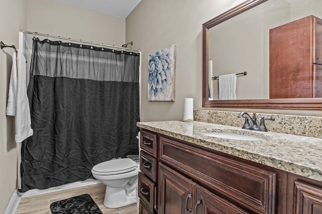 bathroom with vanity, hardwood / wood-style floors, walk in shower, and toilet