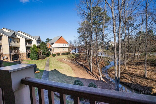 view of community with a water view and a yard