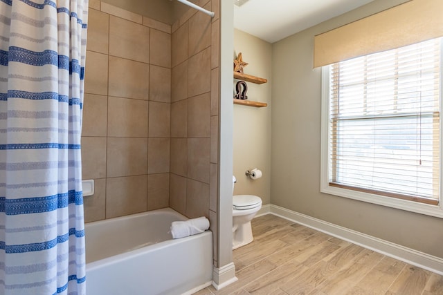 bathroom featuring shower / tub combo with curtain, hardwood / wood-style flooring, and toilet