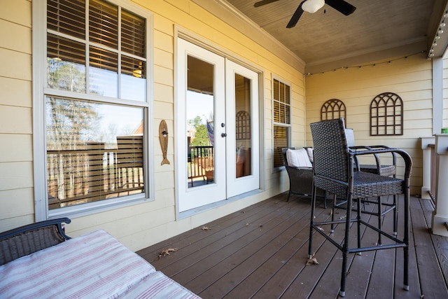 wooden deck featuring ceiling fan and french doors