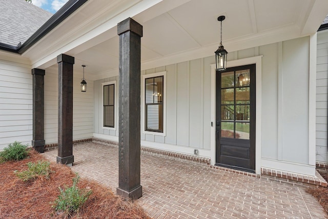 1280 Lake Dr, Greensboro, GA 30642 - view of exterior entry with covered porch and board and batten siding