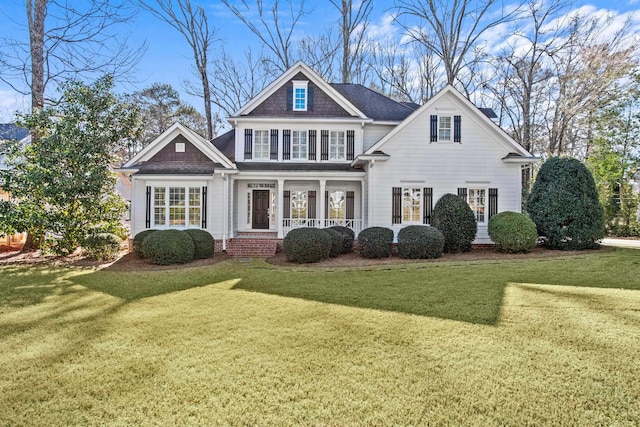 view of front of home with a porch and a front yard