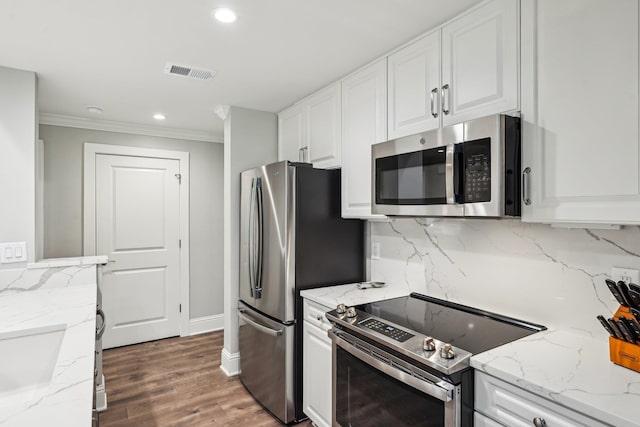 1050A Tailwater, Greensboro, GA 30642 - kitchen featuring appliances with stainless steel finishes, white cabinets, crown molding, backsplash, and wood finished floors
