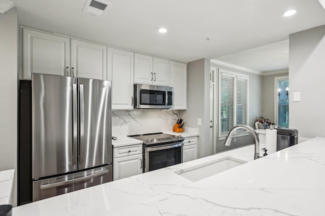 1050A Tailwater, Greensboro, GA 30642 - kitchen with appliances with stainless steel finishes, a sink, recessed lighting, light stone countertops, and decorative backsplash