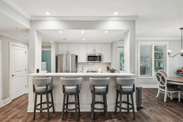 1050A Tailwater, Greensboro, GA 30642 - kitchen with appliances with stainless steel finishes, recessed lighting, tasteful backsplash, white cabinets, and a breakfast bar area