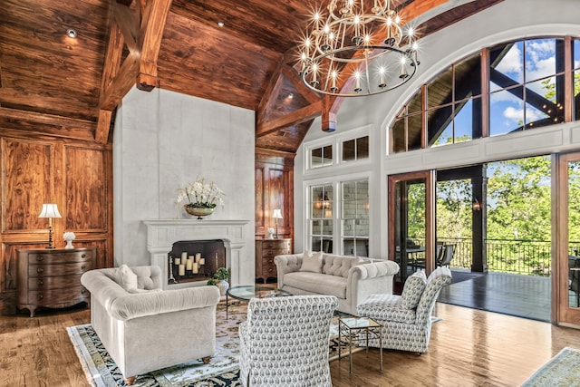 2030 Linger Longer Dr, Greensboro, GA 30642 - living area with high vaulted ceiling, wood finished floors, an inviting chandelier, and plenty of natural light