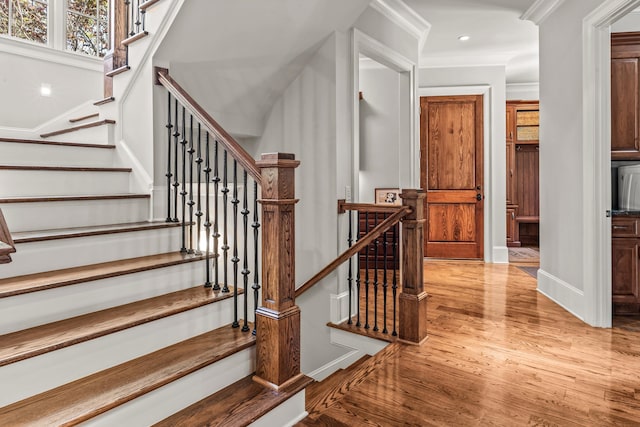 2030 Linger Longer Dr, Greensboro, GA 30642 - staircase featuring wood finished floors, recessed lighting, ornamental molding, and baseboards