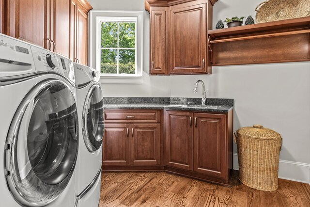 2030 Linger Longer Dr, Greensboro, GA 30642 - clothes washing area with a sink, wood finished floors, cabinet space, and washing machine and dryer