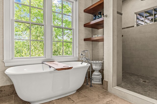 2030 Linger Longer Dr, Greensboro, GA 30642 - bathroom with a tile shower, a freestanding tub, and plenty of natural light