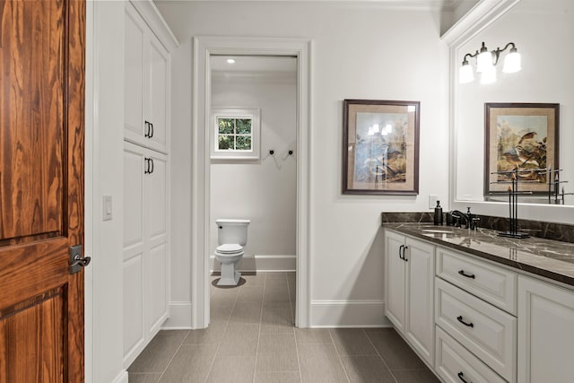 2030 Linger Longer Dr, Greensboro, GA 30642 - bathroom with baseboards, toilet, ornamental molding, tile patterned floors, and vanity