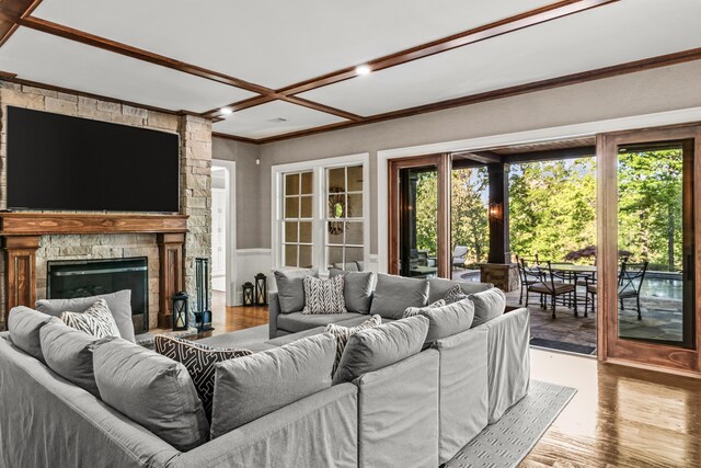 2030 Linger Longer Dr, Greensboro, GA 30642 - living area featuring a fireplace, wood finished floors, ornamental molding, and wainscoting