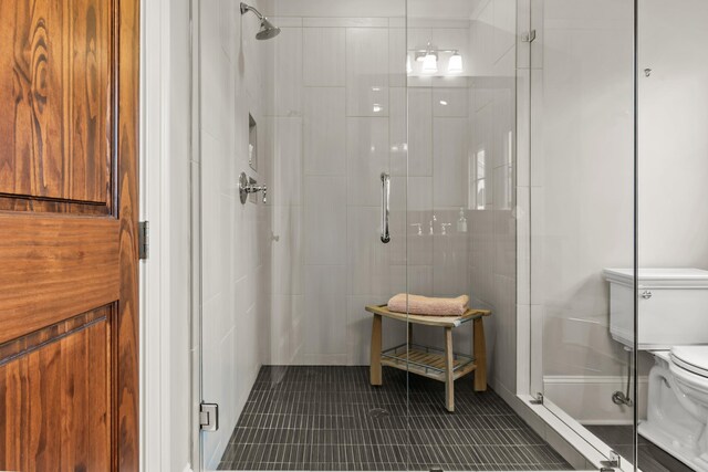 2030 Linger Longer Dr, Greensboro, GA 30642 - bathroom featuring toilet, a shower stall, and tile patterned flooring