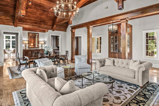2030 Linger Longer Dr, Greensboro, GA 30642 - living room featuring wooden ceiling, a chandelier, beamed ceiling, and decorative columns