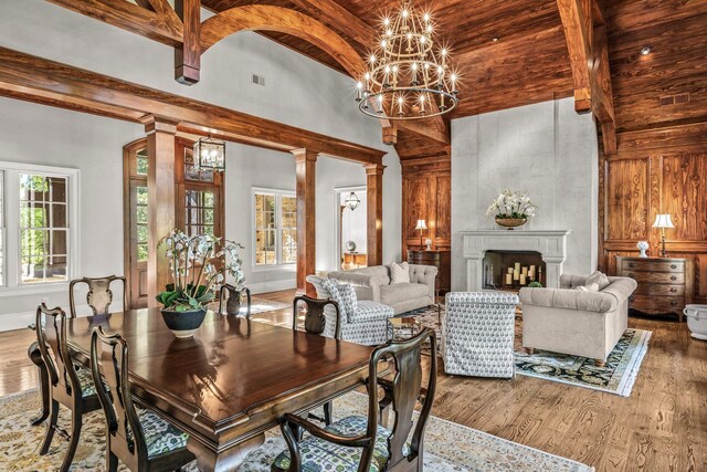 2030 Linger Longer Dr, Greensboro, GA 30642 - dining room featuring wood finished floors, ornate columns, an inviting chandelier, visible vents, and a towering ceiling