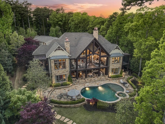 2030 Linger Longer Dr, Greensboro, GA 30642 - back of property featuring a chimney, a standing seam roof, a patio, and stone siding