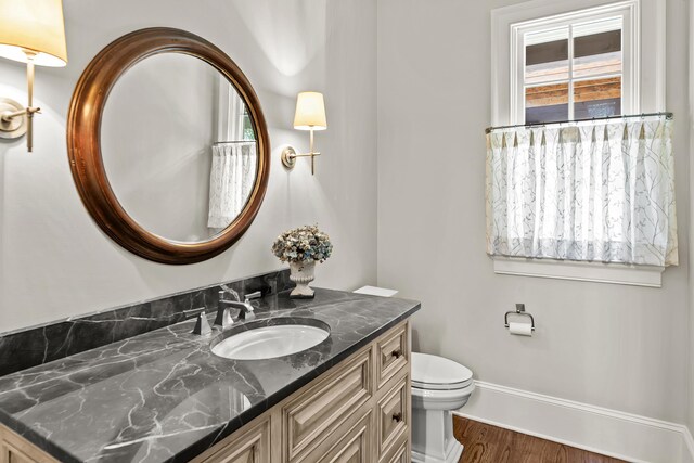 2030 Linger Longer Dr, Greensboro, GA 30642 - bathroom with baseboards, wood finished floors, toilet, and vanity